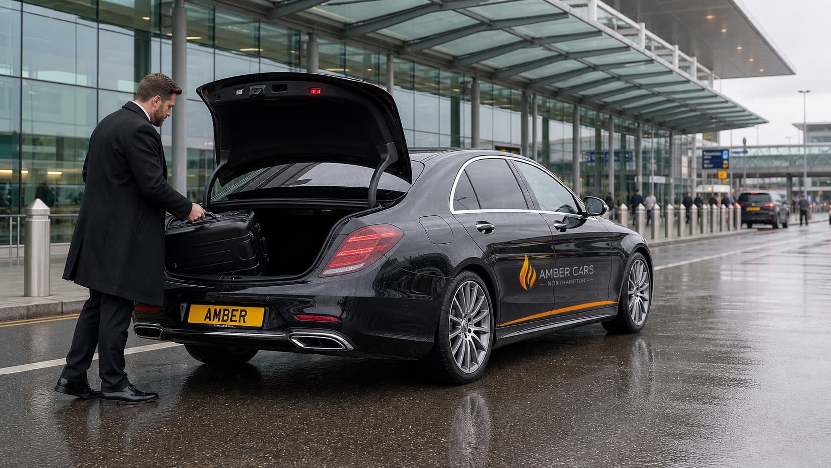Amber Cars airport transfer loading luggage at an airport terminal